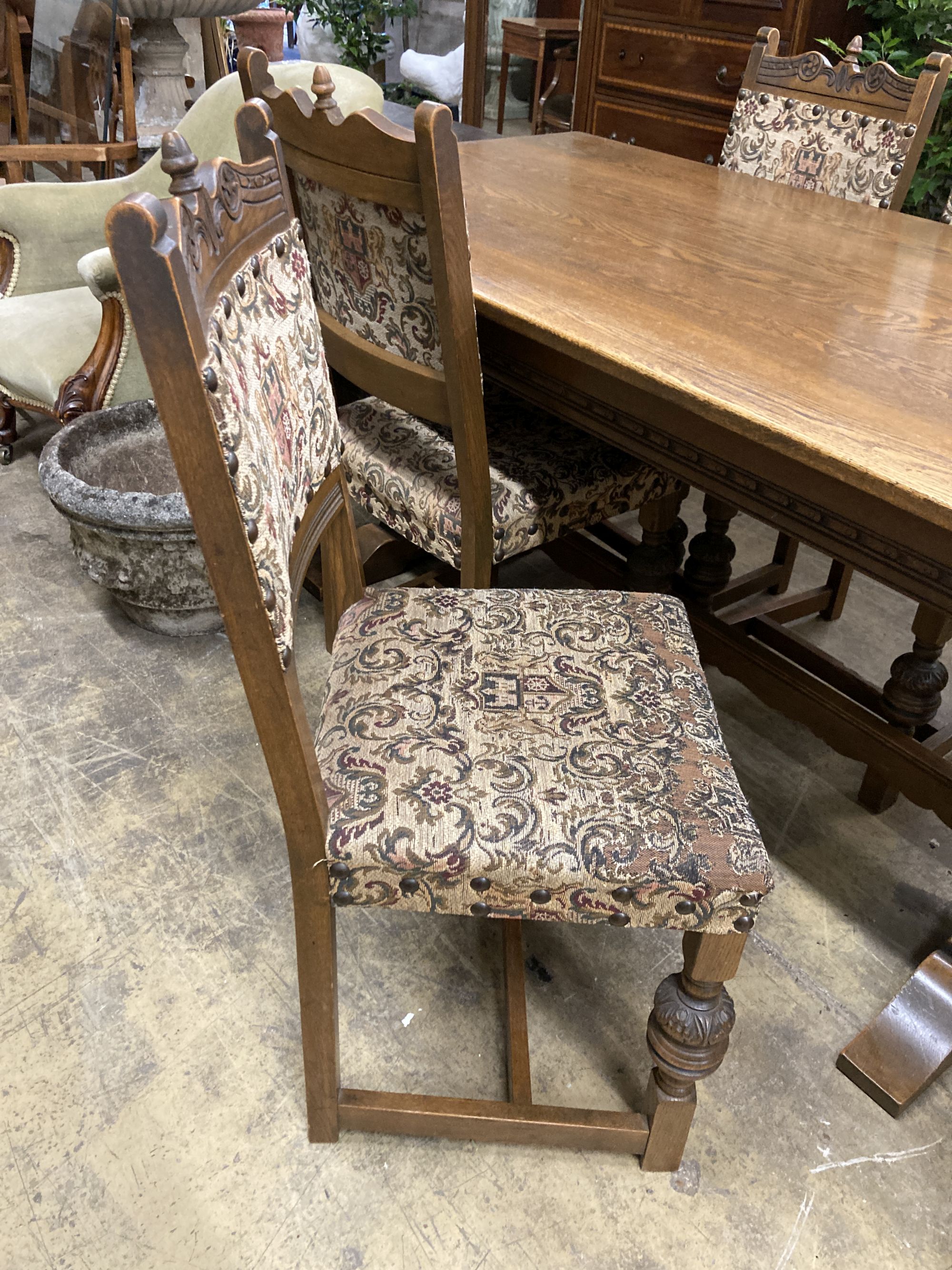 A rectangular 18th century style oak refectory dining table, length 182cm, depth 91cm, height 78cm, together with six matching dining chairs (two with arms)